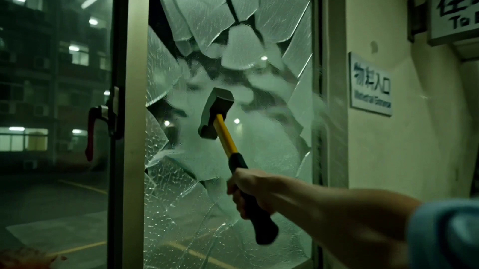 First-person view of using a hammer to break the reception window