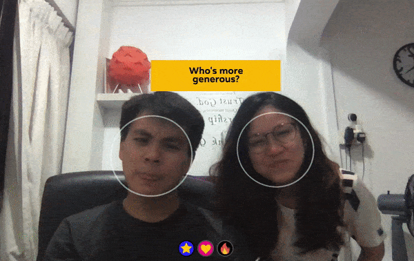 Two people playing Who Is More by tilting their heads