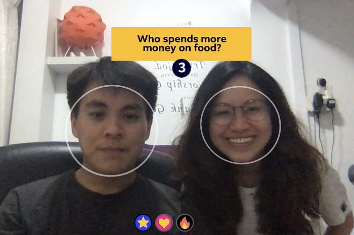 Two players framed by face-tracking circles beneath ‘Who spends more money on food?’, with a countdown of 3 and three game-mode icons.